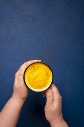 Turmeric latte held in hands