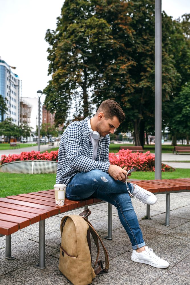 Young male using tablet outdoors