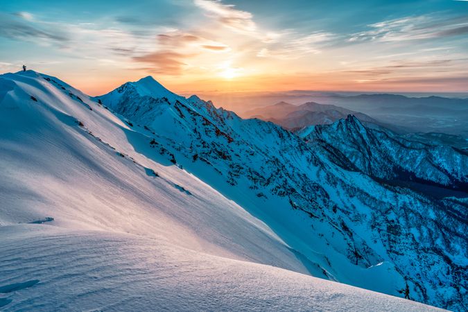 Snow covered mountain under blue sky