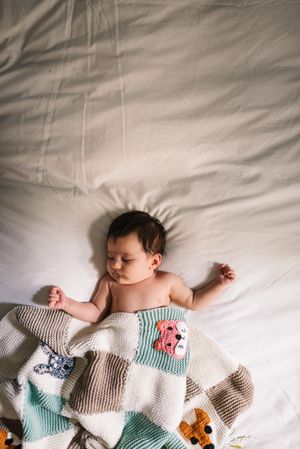 Cute baby sleeping on bed