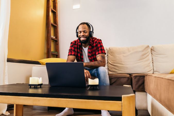Black man making work video call with laptop at home
