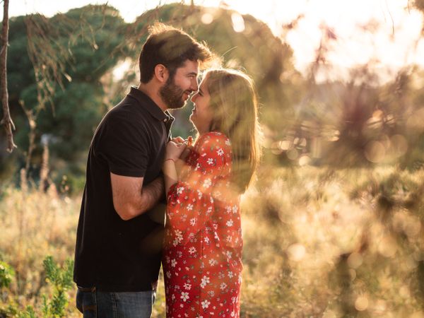 Young happy couple embracing in beautiful garden