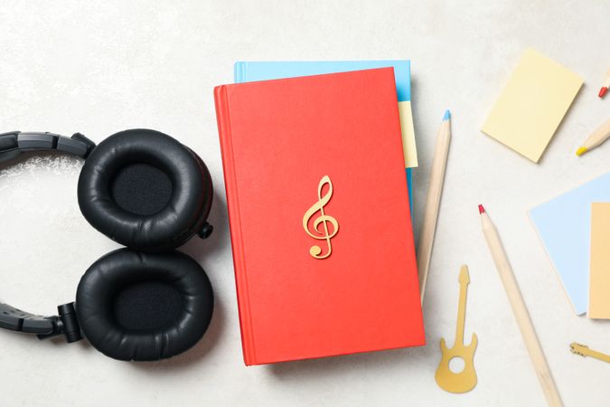Concept of audiobook with books and headphones, top view