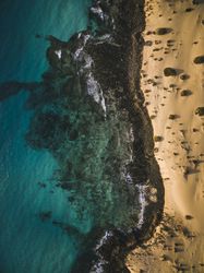Aerial shot of coastal blue waters