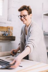 Female potter rolling strips of clay