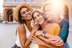 Smiling multi-ethnic female having fun on summer holidays in city street
