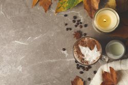 Composition with glass cup of latte on gray background