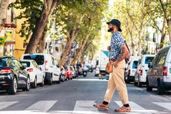 Stylish Black man walking on the city street