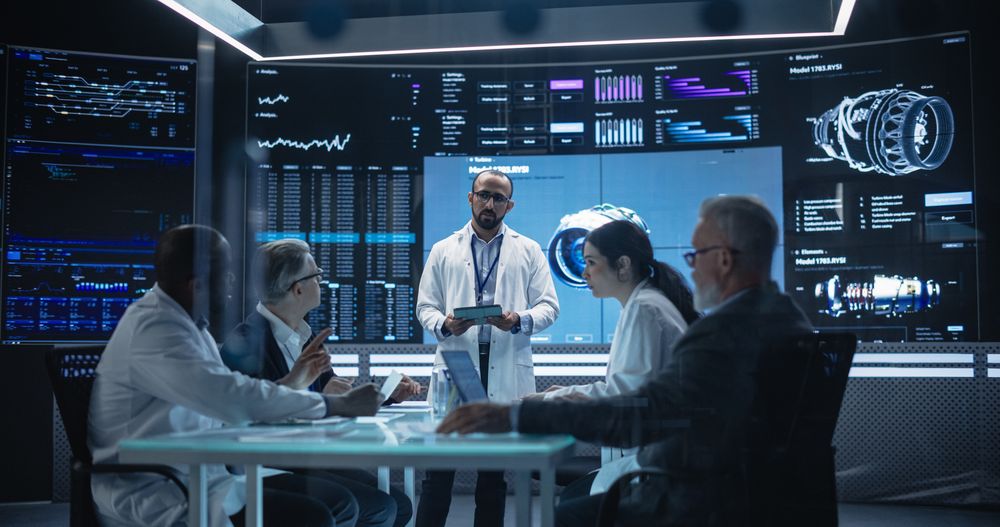 Chief Engineer Conducting a Quality Assessment Meeting With His Industrial Design Team.