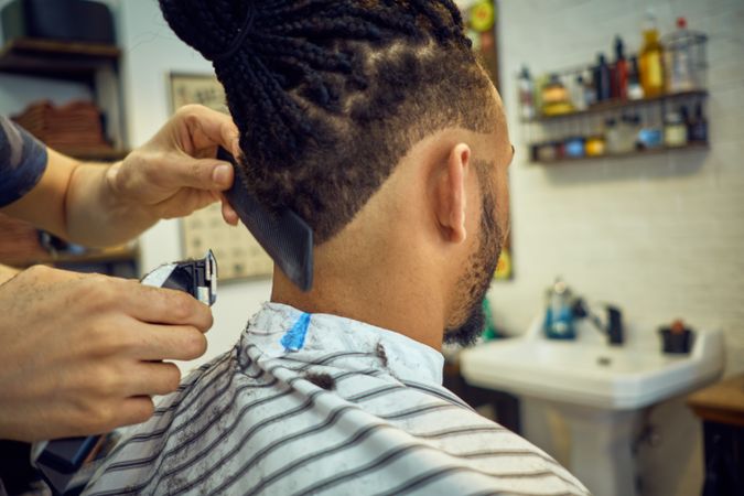 Anonymous hairstylist doing a haircut
