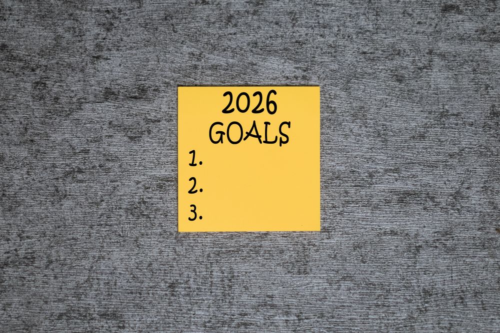 2026 plan words text on yellow sticky notes blocks on grey table background
