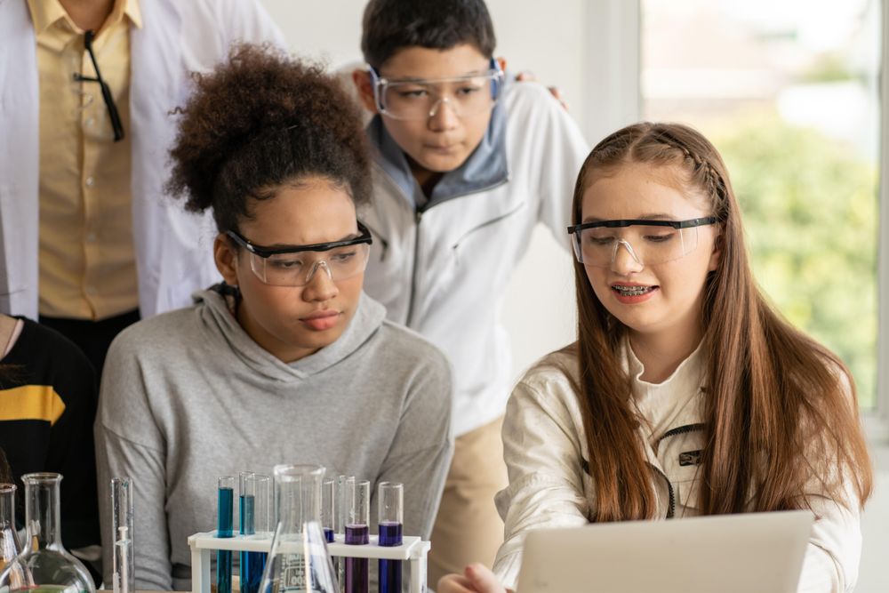 Enthusiastic multi-ethnic students in protective eye wear