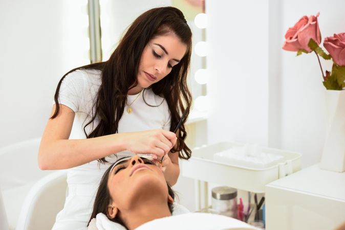 Woman having eye brow treatment in beauty salon