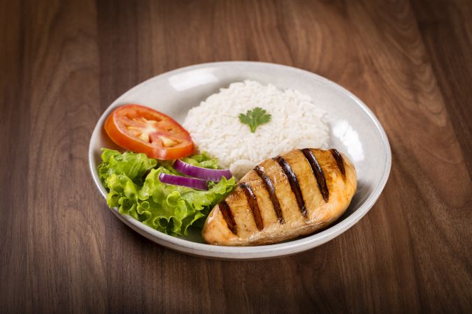 Grilled chicken with salad and rice.