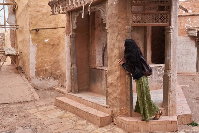 Woman on street between ancient buildings