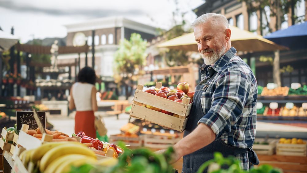 Male Farmer Managing a Small Business on an Outdoors Farmers Market