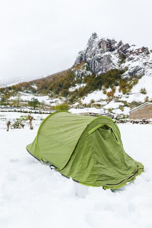 Green tent in snowy landscape