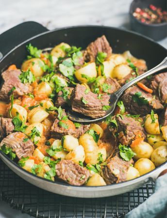 Braised beef stew with potatoes, carrots and parsley