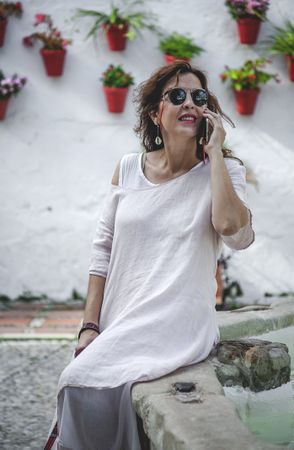 Confident woman calling on phone in town