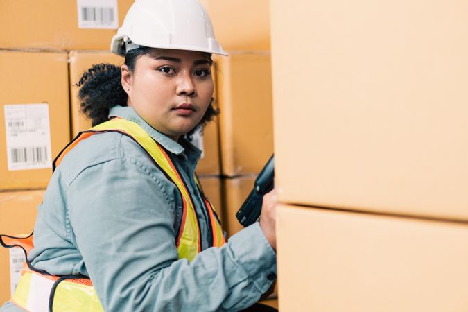 Woman in safety gear working in distribution center