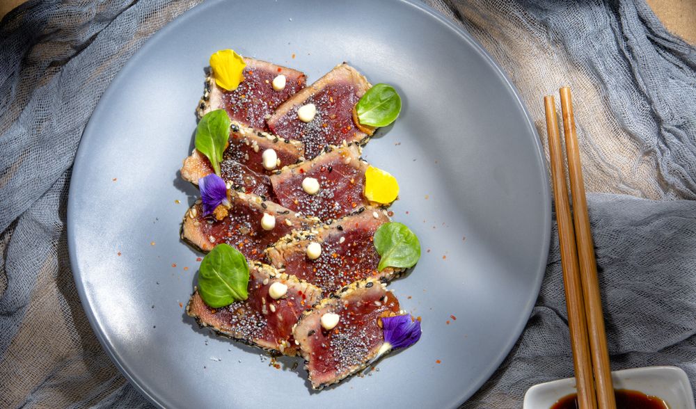 Tasty tuna tataki decorated with green and seeds