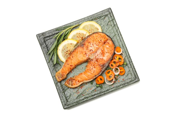 Plate with grilled salmon isolated on blank background