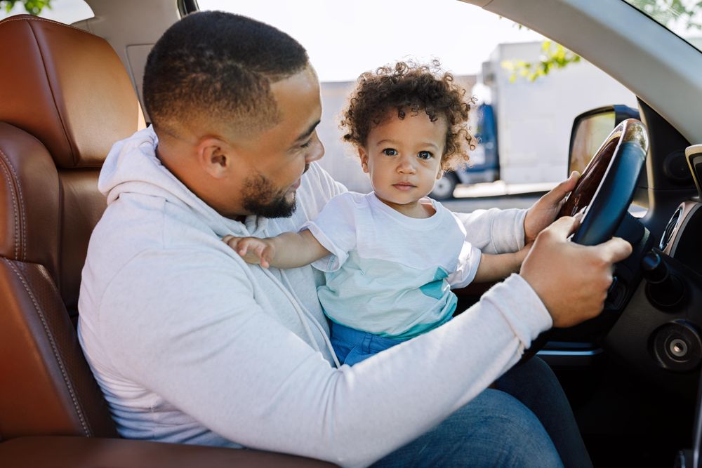 Parent playing with son in car