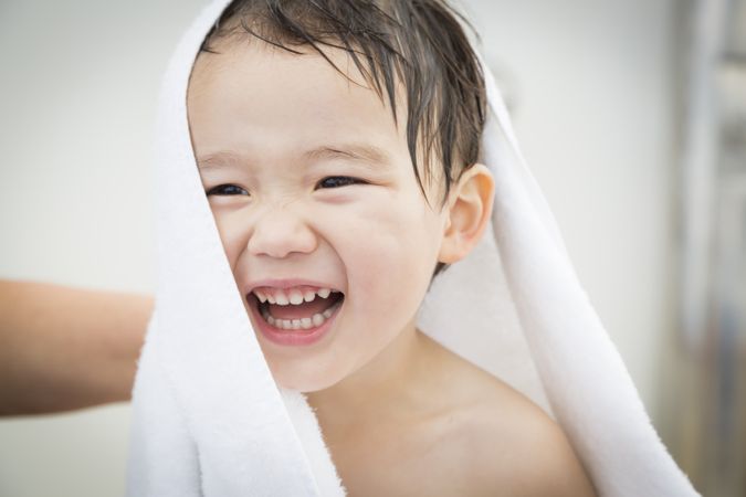 Boy Having Fun and Wrapped in Towel at the Water Park