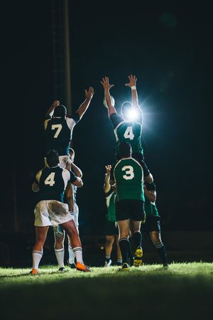Rugby players jumping for line out at the stadium