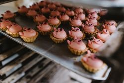 Tray with pig shaped desserts in bakery