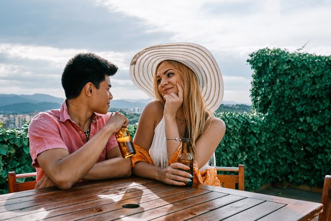 A woman and man in love sitting with beautiful view