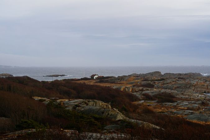 Rocky seashore and dark wavy sea in dusk