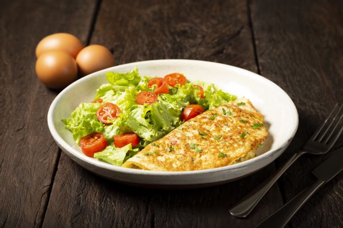 Omelet with cheese and lettuce and tomato salad.