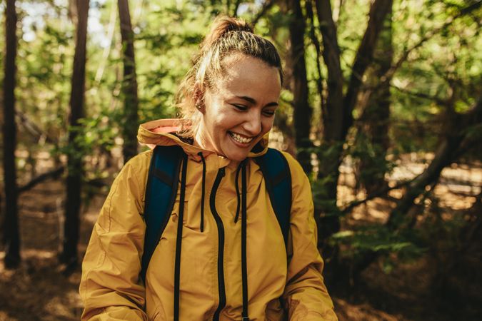 Female camper smiling standing in a forest
