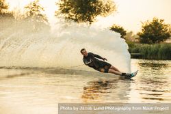 Man showing off his water skiing skills on a lake 4A6Azb