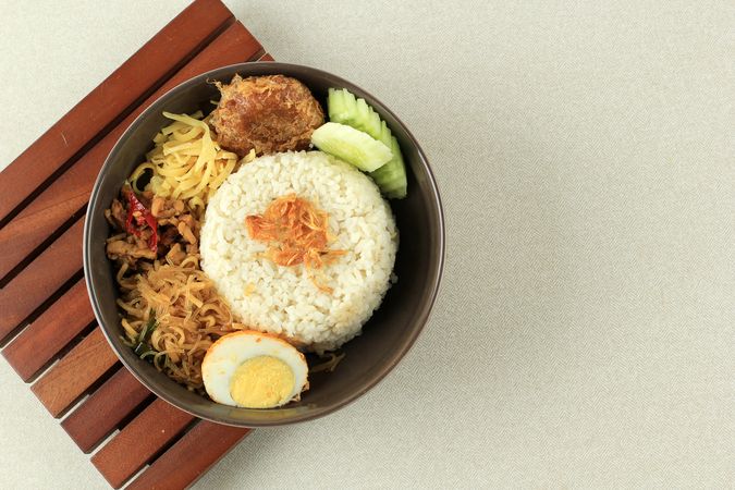 Top view of Indonesian breakfast nasi uduk with fried shallots