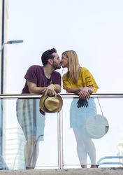 Couple kissing on bridge