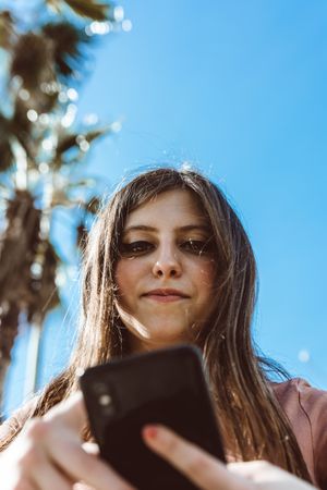 Teen girl looking at her smartphone.