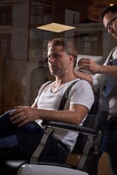 Stylish adult man in barber shop