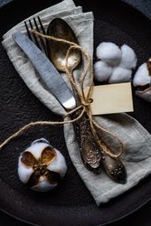 Top view of plate with decorative cotton and feathers with napkin
