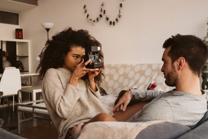 Black woman taking picture of boyfriend