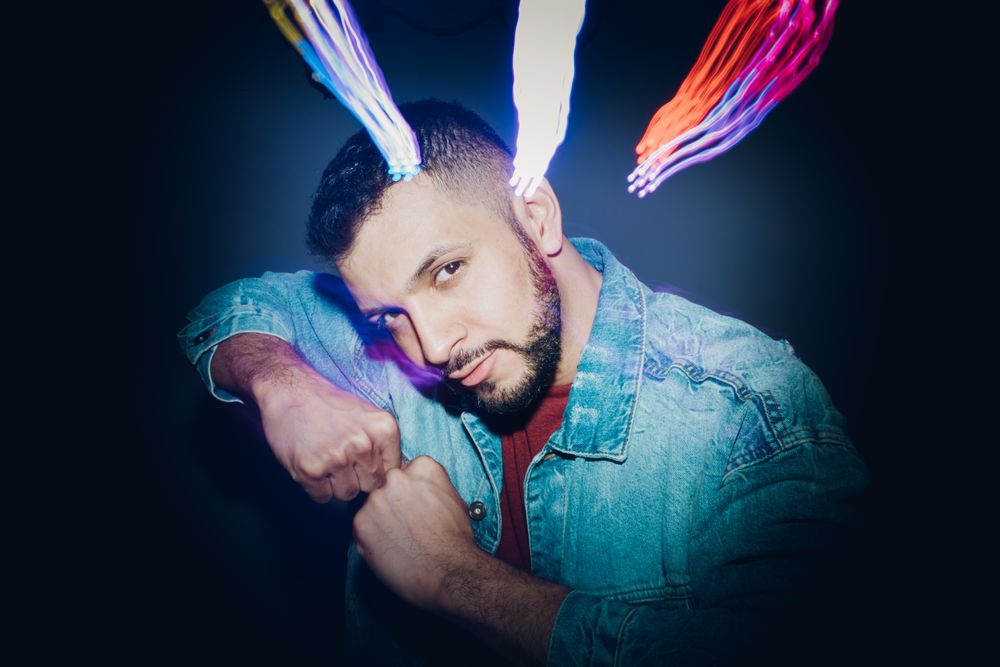 bearded man dancing in spotlight