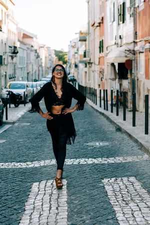 Joyful trendy female in old town street