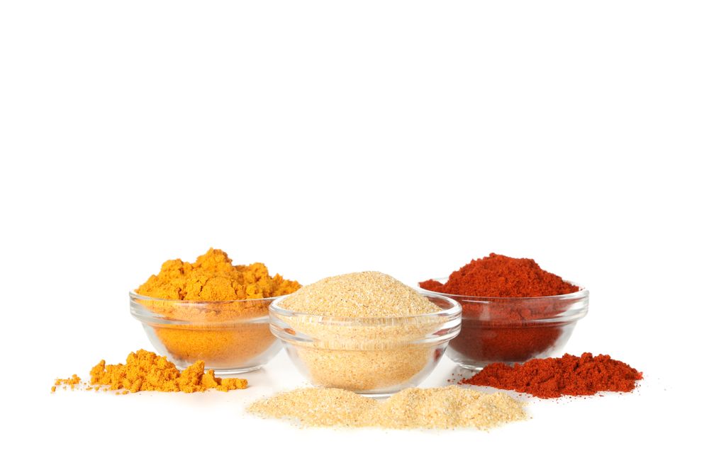 Three glass bowls of earthy spices