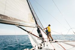 Two men maneuvering sail on yacht