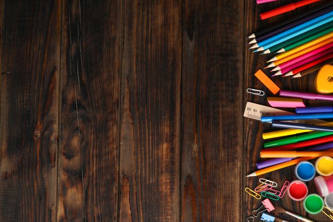 Flat lay composition with school supplies on wooden background, space for text