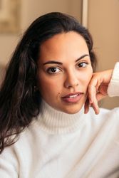 young woman sitting on sofa near window with warm light