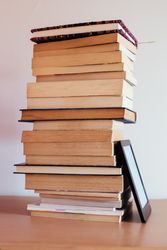 Vintage books next to an e-Book