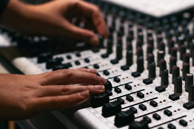 Hand Adjusts The Tone Of The Synthesizer