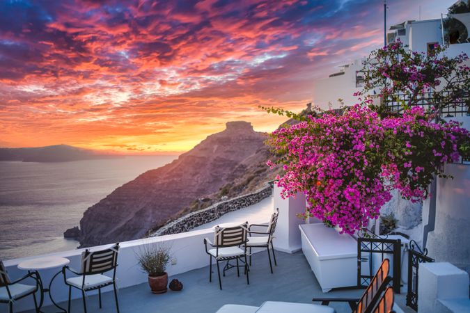 Patio overlooking the sea with a colorful sunset in Greece